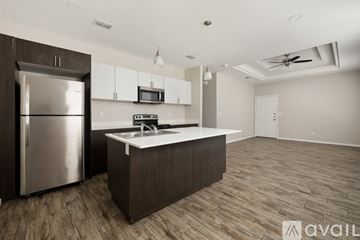 Alton apartment for rent - A kitchen with a refrigerator, microwave, and a countertop.