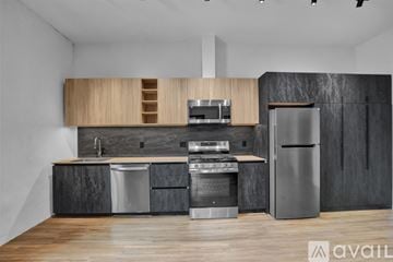 Scranton apartment for rent - A modern kitchen with stainless steel appliances and wooden floors.
