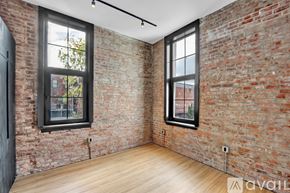 Scranton apartment for rent - A black and wood interior space with a window showing a balcony.