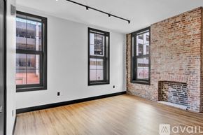 Scranton apartment for rent - A room with a wooden floor and a black door.