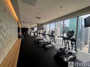 Miami condo for rent - A gym with exercise bikes and a view of the city.