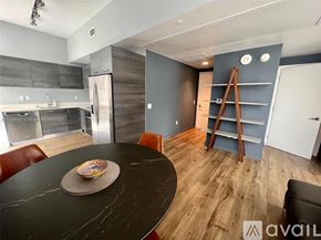 Miami condo for rent - A modern kitchen with a black table and chairs.