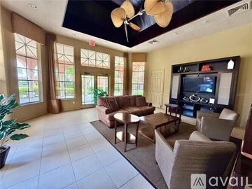 Orlando apartment for rent - A living room with a television and a large window.