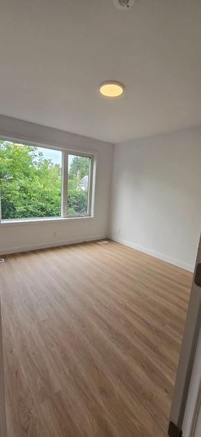 Ottawa apartment for rent - A room with a window and wooden flooring.