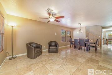 Oro Valley house for rent - A living room with a brown leather chair and a brown leather armchair.