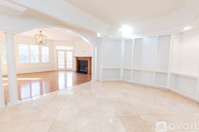 Winter Park apartment for rent - A spacious room with a fireplace and large windows.