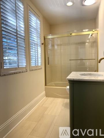 Winter Park apartment for rent - A kitchen with white cabinets and black and white tiles.