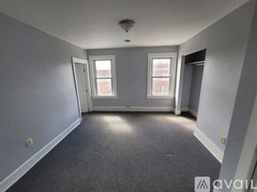 Albany apartment for rent - A room with grey carpet and two windows.