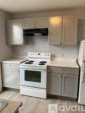 Albany apartment for rent - A kitchen with white appliances and cabinets.