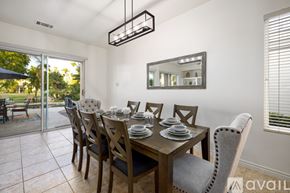 La Quinta house for rent - A dining room with a table set for six with a view of the backyard.