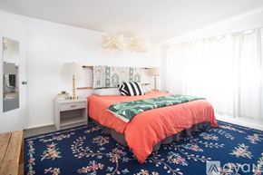 Joshua Tree house for rent - A bedroom with a bed, nightstand, and lamp.