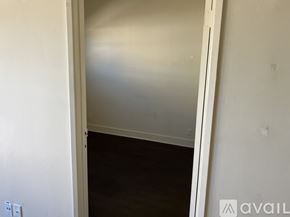 Los Angeles apartment for rent - A room with a white wall and a wooden floor.