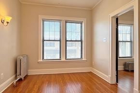 Oak Park apartment for rent - A room with wooden floors and two windows.