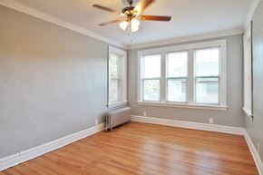 Oak Park apartment for rent - an empty room with wood floors and a ceiling fan