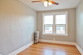 Oak Park apartment for rent - an empty room with a ceiling fan and two windows