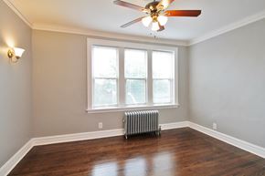 Oak Park apartment for rent - a living room with a radiator and a ceiling fan
