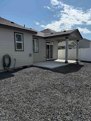 Hermiston house for rent - A house with a grey roof and a covered patio.