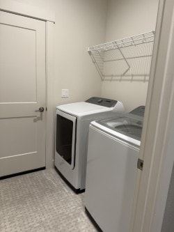 Hermiston house for rent - A white door is open to a room with a white fridge and a white microwave.