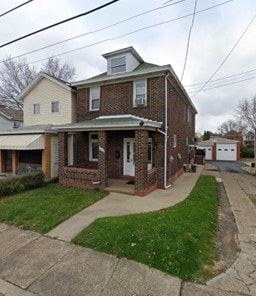 Homestead house for rent - A house with a green roof and a brick facade.