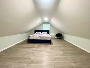 Charlestown house for rent - A bedroom with a bed and a chair.