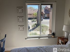 Winter Park condo for rent - A bedroom with a large window overlooking a street.