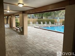 Winter Park condo for rent - A patio with a pool and chairs.