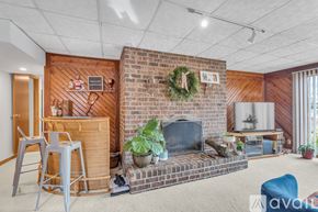 Reston house for rent - A living room with a fireplace and a wreath on the wall.