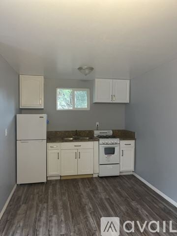 Riverside house for rent - A kitchen with white appliances and cabinets.