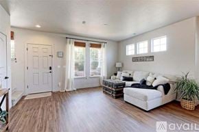Thornton townhouse for rent - A living room with a white couch and wooden floors.