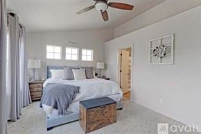Thornton townhouse for rent - A bedroom with a large bed and a ceiling fan.