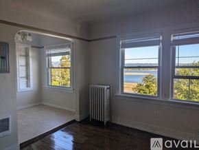 St. Helens apartment for rent - A room with a large window overlooking a parking lot and a body of water.