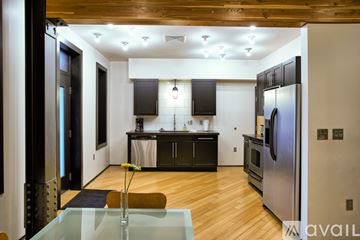 Williamsport apartment for rent - A modern kitchen with a glass table and stainless steel appliances.