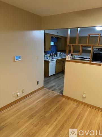 Milwaukee house for rent - A kitchen with wooden floors and a countertop with a sink.