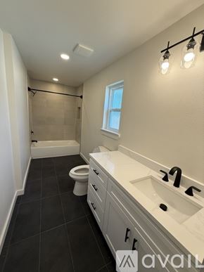 Arlington townhouse for rent - A bathroom with a toilet, sink, and a window.