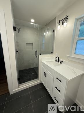 Arlington townhouse for rent - A bathroom with a walk-in shower and a vanity with a sink.