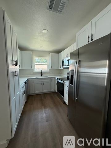 Arlington townhouse for rent - A kitchen with white cabinets and a stainless steel refrigerator.