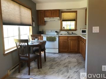 Whitehouse Station house for rent - A kitchen with a table and chairs in front of a window.