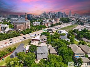 Dallas townhouse for rent - A cityscape with a mix of residential and commercial buildings under a twilight sky.
