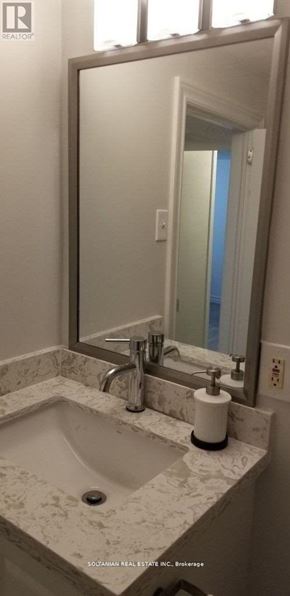 Toronto (West Hill) house for rent - A bathroom with a marble sink and a large mirror.