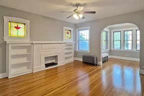 Oak Park apartment for rent - A room with a fireplace and a ceiling fan.