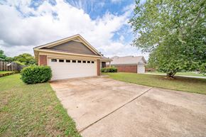 Columbus house for rent - A two-car garage is attached to a brick house.