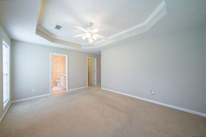 Columbus house for rent - A spacious room with a ceiling fan and carpeted floor.