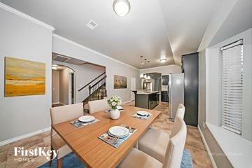 Edmond house for rent - A dining room with a wooden table set for two.