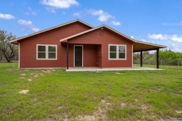 San Antonio house for rent - A red house with a brown roof and a covered porch.