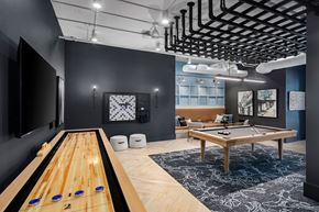 Charlotte apartment for rent - A room with a pool table and a shelf with bottles.