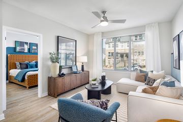 Charlotte apartment for rent - A living room with a blue chair and a white couch.