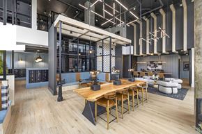 Charlotte apartment for rent - A modern dining area with a long wooden table and chairs.