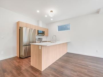 Edmonton apartment for rent - A kitchen with a wooden counter and a stainless steel refrigerator.