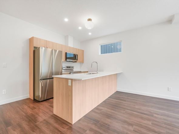 Edmonton apartment for rent - A kitchen with a wooden counter and a stainless steel refrigerator.