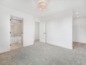 Edmonton apartment for rent - A spacious, empty room with a carpeted floor and white walls.